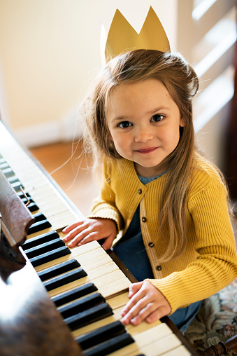Adorable Cute Girl Playing Piano Concept